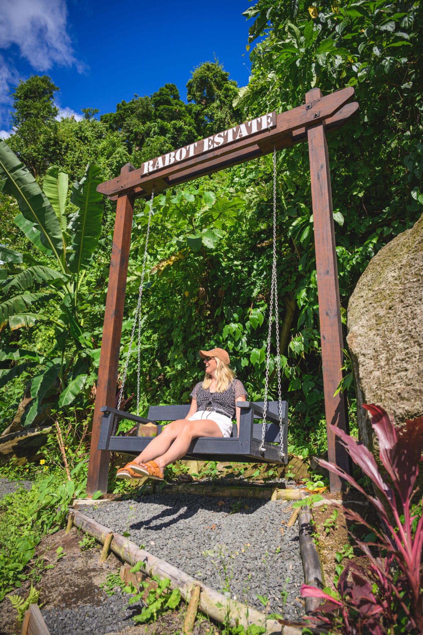 Woman sat on swing in Rabot Estate, Saint Lucia