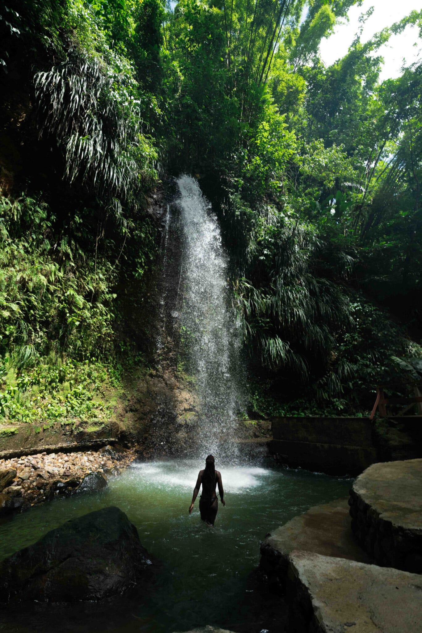 Woman in waterfall in Saint Lucia